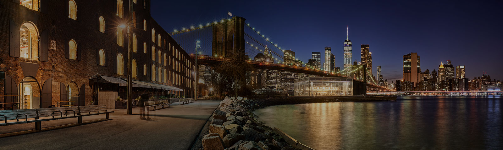 bridge and lake at nighttime with city lights