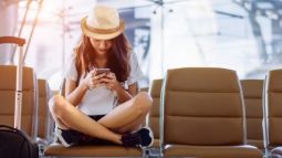 woman on phone with luggage