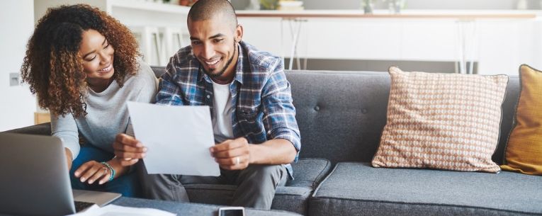 Allianz - couple reviewing their travel insurance policy documents