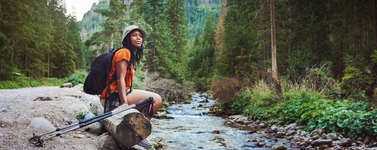 Allianz - woman hiking alone in forest