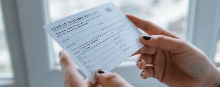 Allianz - woman holding vaccine card